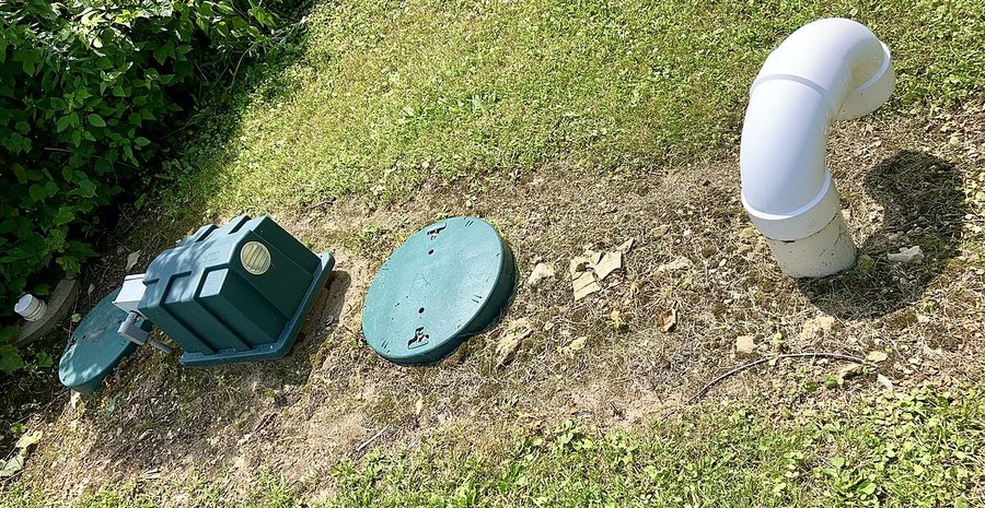 Open septic tank being inspected