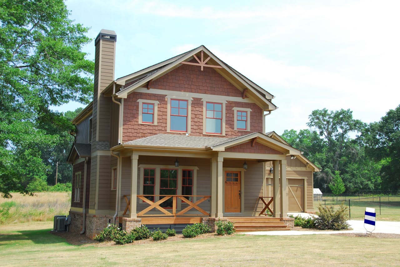 Craftsman-style home surrounded by mature trees